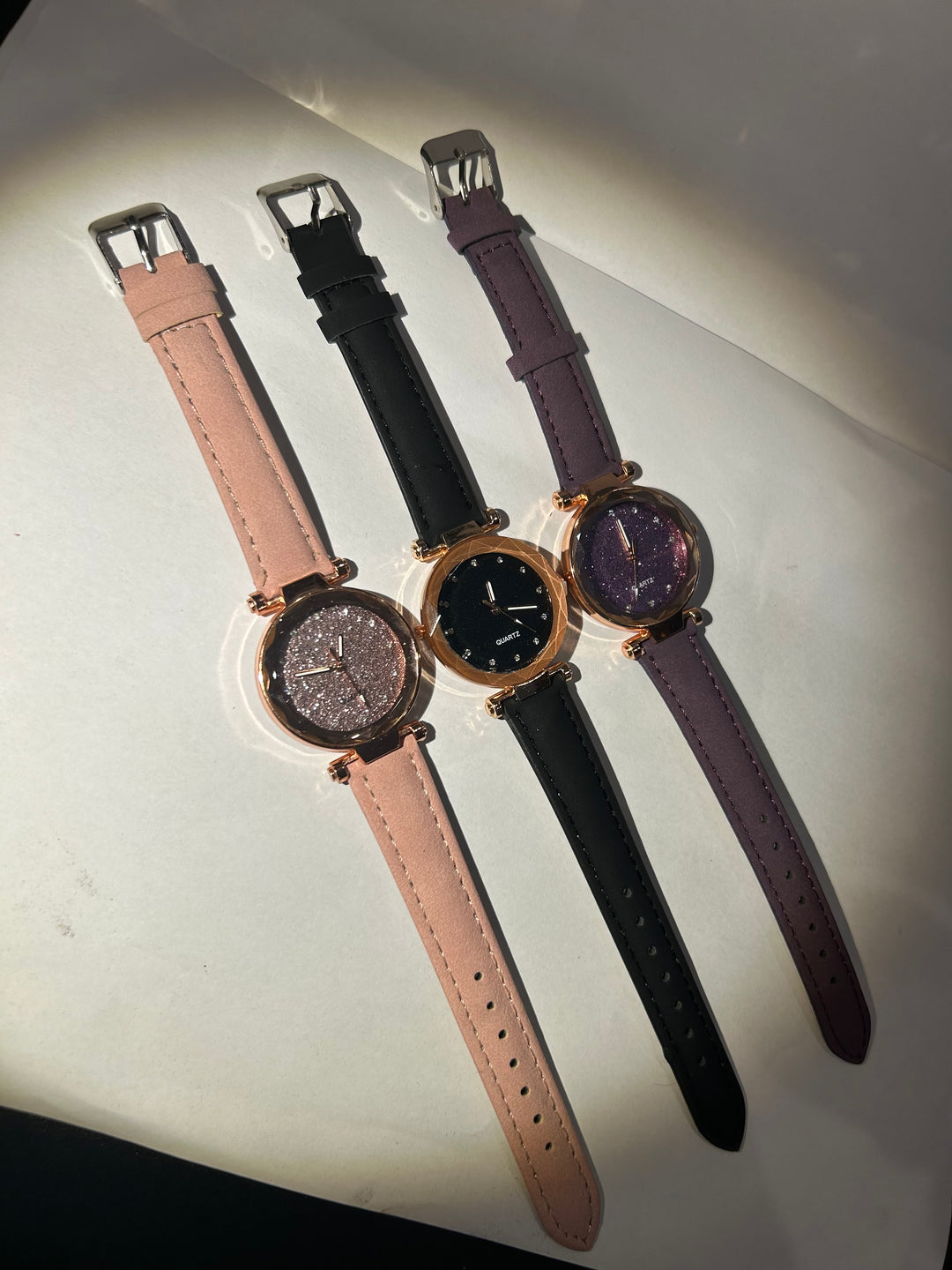 Glitter-faced watches with rose gold hardware and adjustable straps 