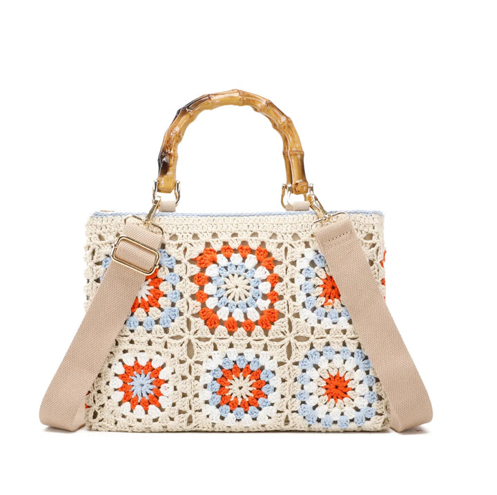 Cream crochet grab bags with bamboo handles and gold tone metal hardware.