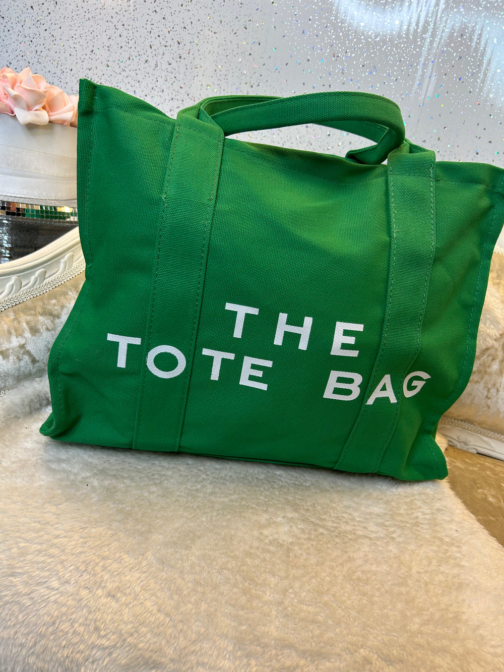 Green canvas tote bag with 'THE TOTE BAG' text