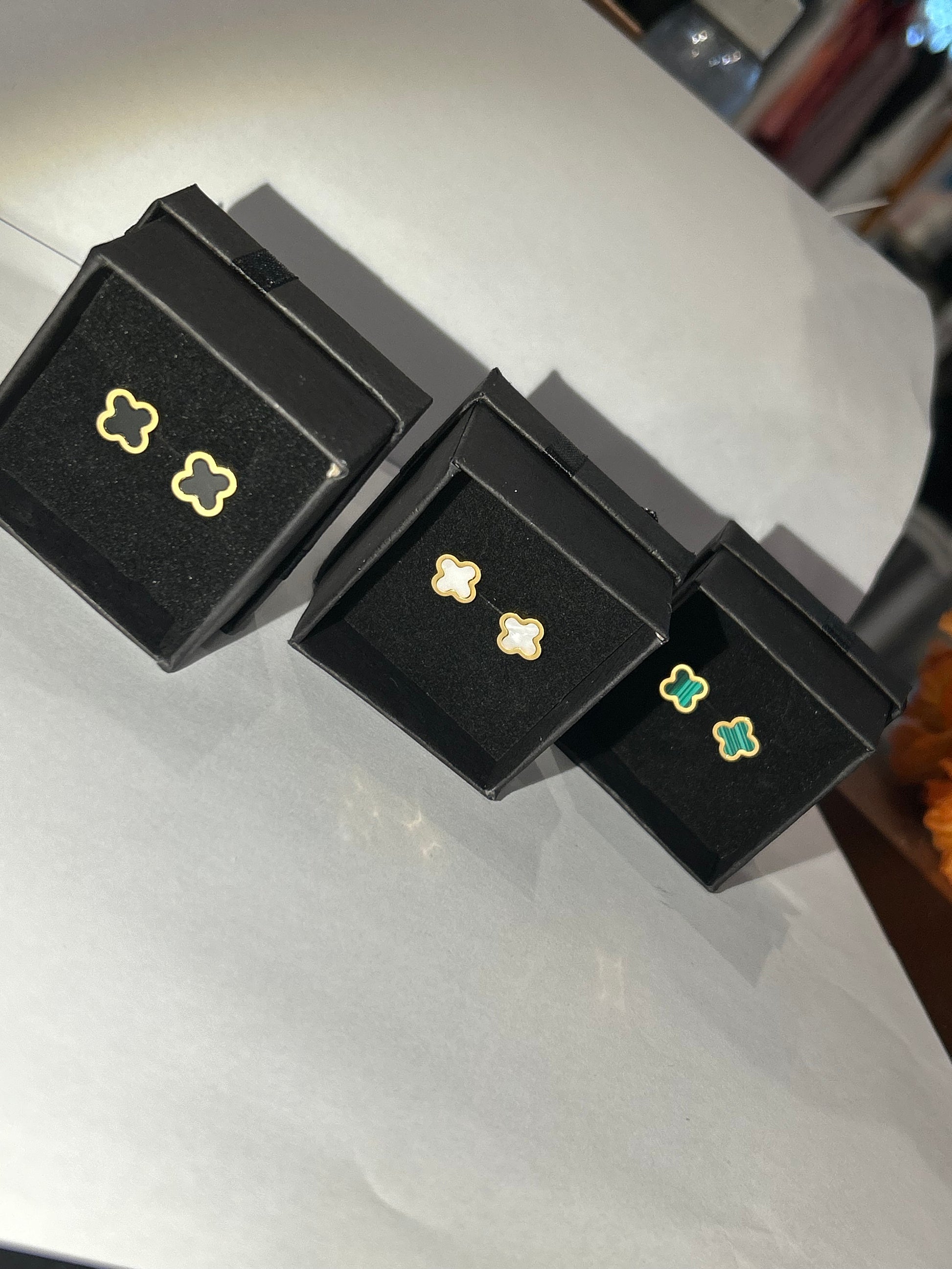 Black green and white clover shaped gold earrings 