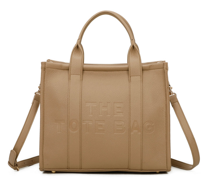 A beige tote bag with embossed ‘The Tote Bag’ text, structured design with top handles and detachable shoulder strap