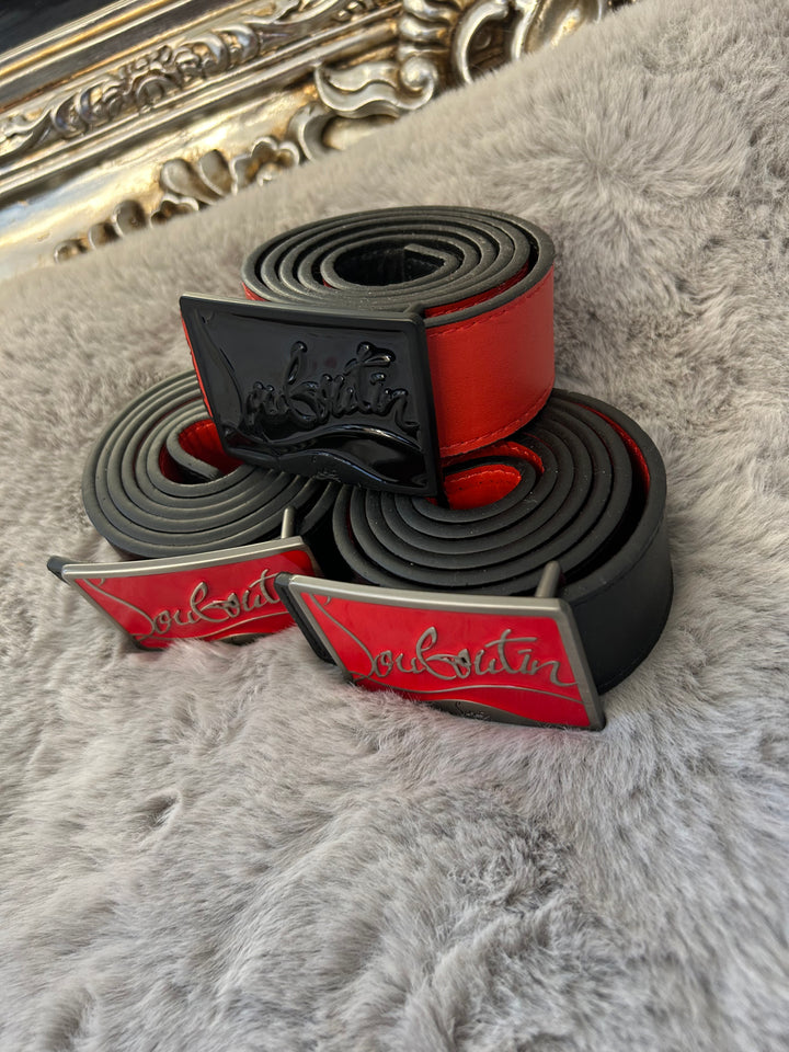 Two belts with red and black colour scheme one with black buckle