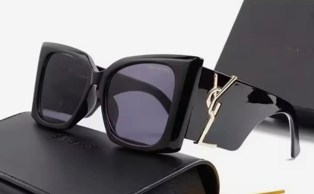 Black chunky sunglasses with a gold logo 