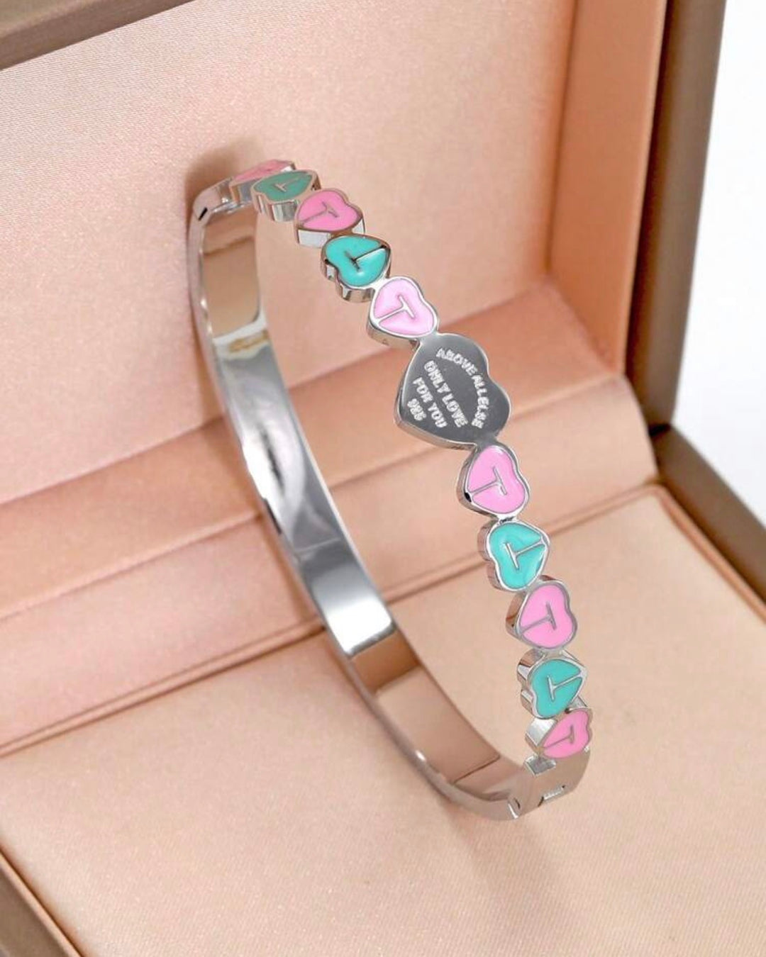 Silver three-piece stainless steel love bangle bracelet set with heart charms and crystal detailing.