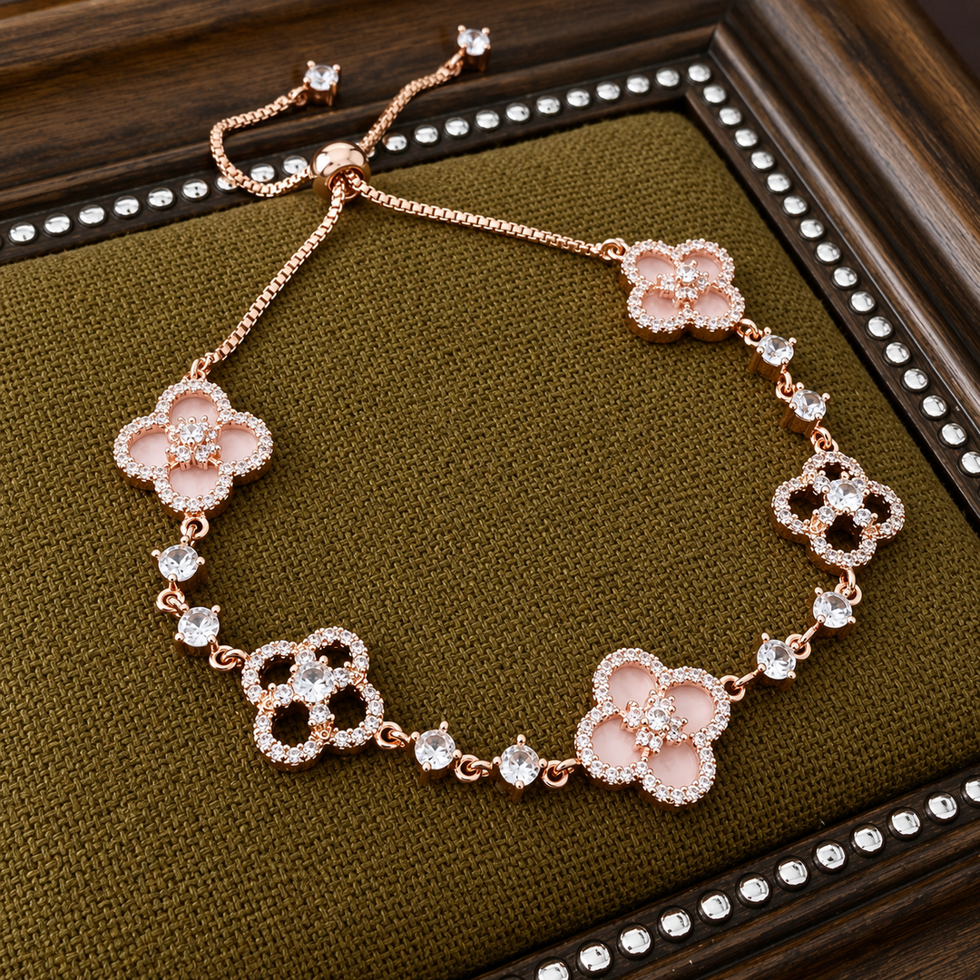 Rose gold adjustable bracelet featuring pink clover charms and sparkling crystal accents 