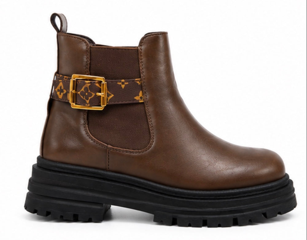 Chocolate brown chunky Chelsea ankle boots with patterned buckle strap and black cleated sole