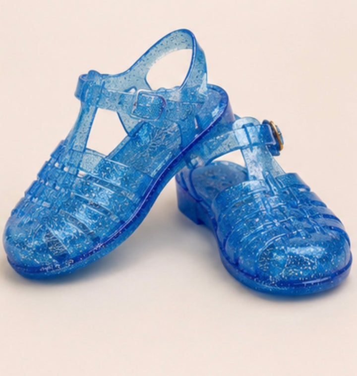 Children’s glitter jelly sandals available in blue and black with buckle ankle straps and flexible sparkly design