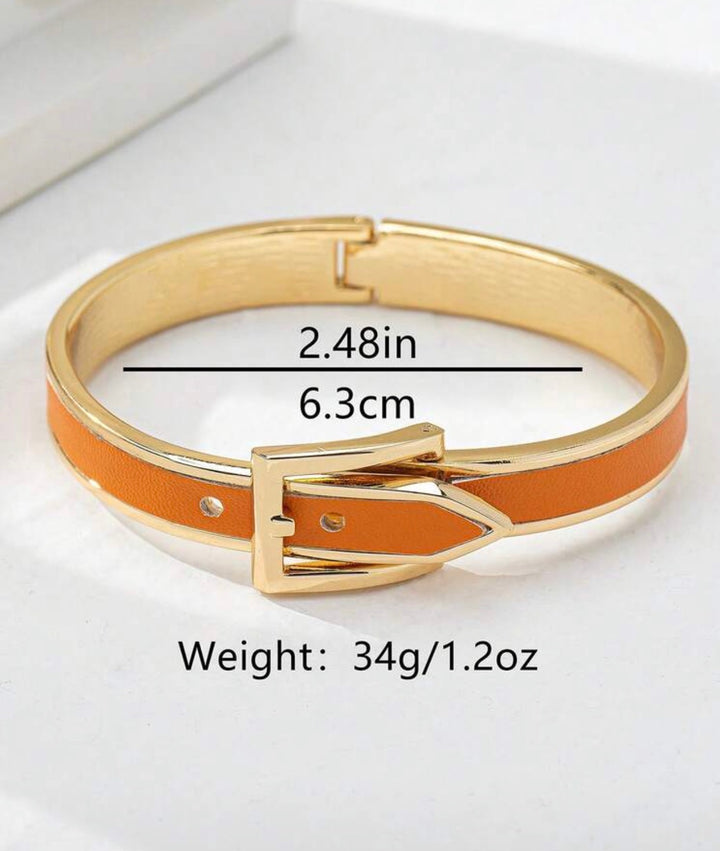     Polished gold buckle cuff bracelet with orange enamel detail