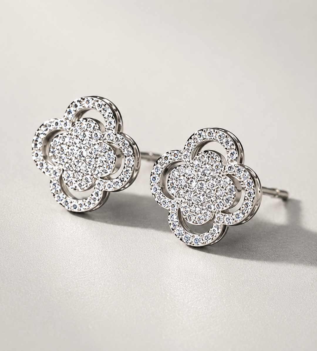 Silver crystal clover stud earrings with sparkling pavé detailing 