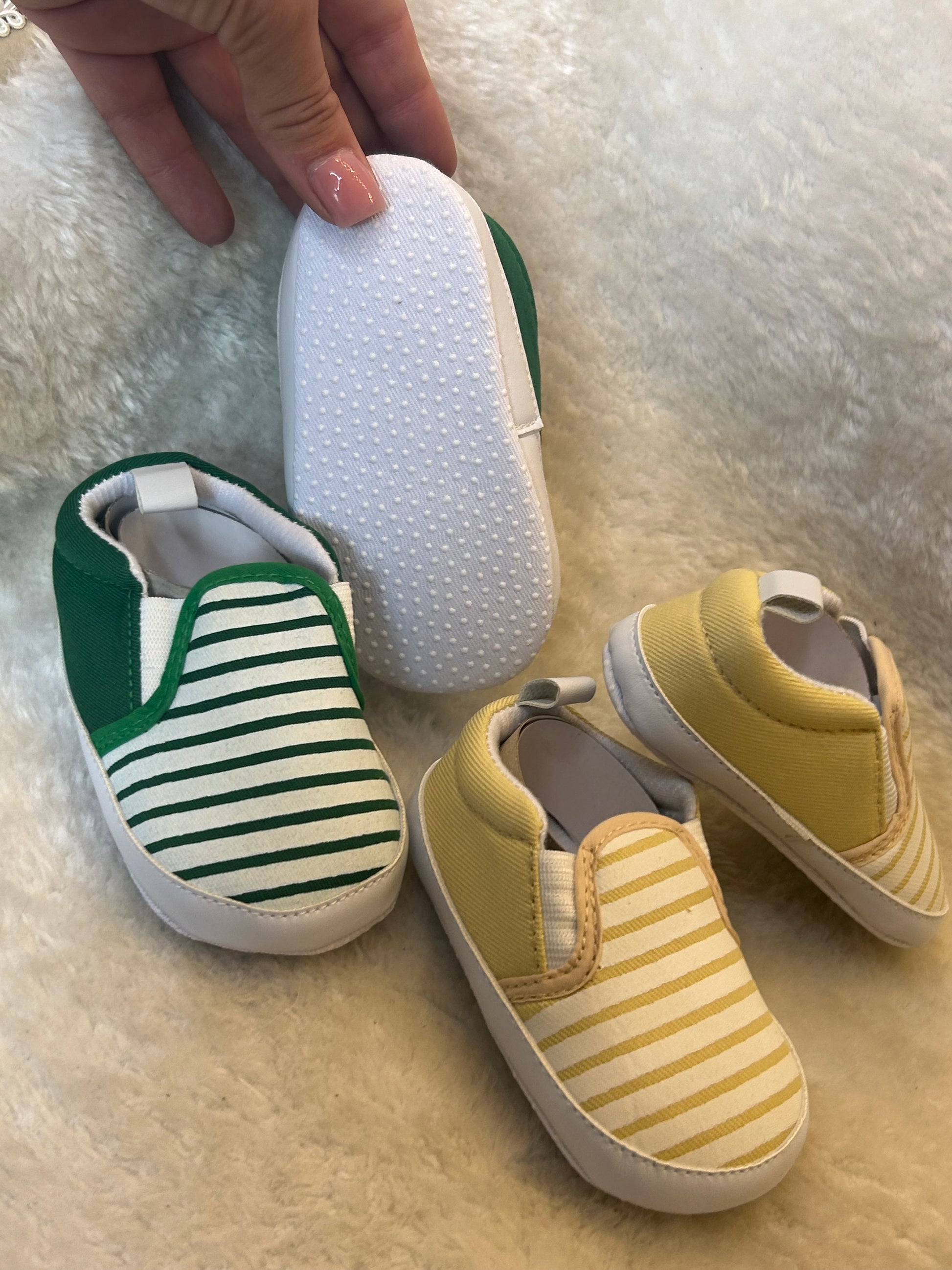 Baby slip-on shoes with striped design, soft white soles with grip dots