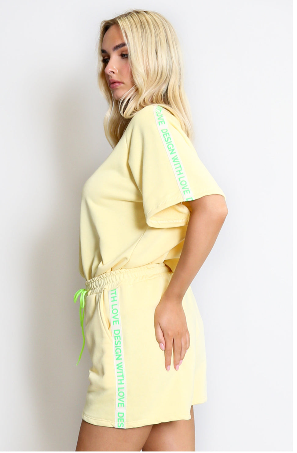 a light yellow outfit with green text