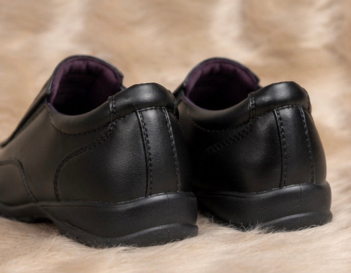 Boys black smart shoes with smooth leather-look finish and comfortable low wedge sole.