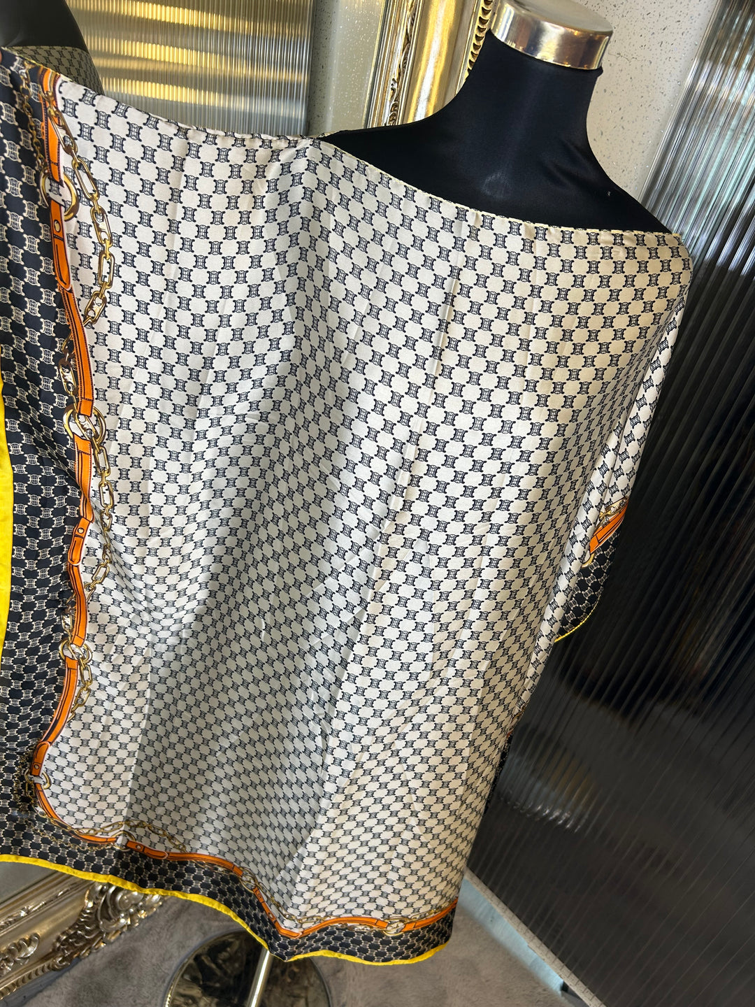 Beige and black inspired print kaftan with orange and yellow strip around the edge 