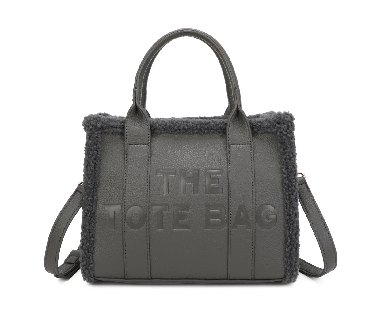 Tote bags with fuzzy edge trim, embossed with ‘The Tote Bag’ on the front in grey
