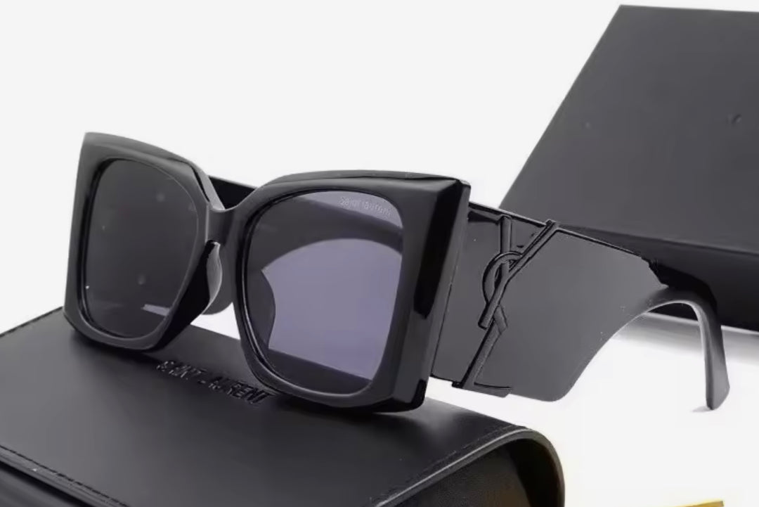 Black chunky sunglasses with a black logo 