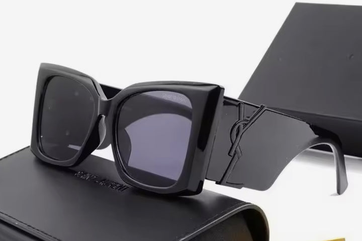 Black chunky sunglasses with a black logo 