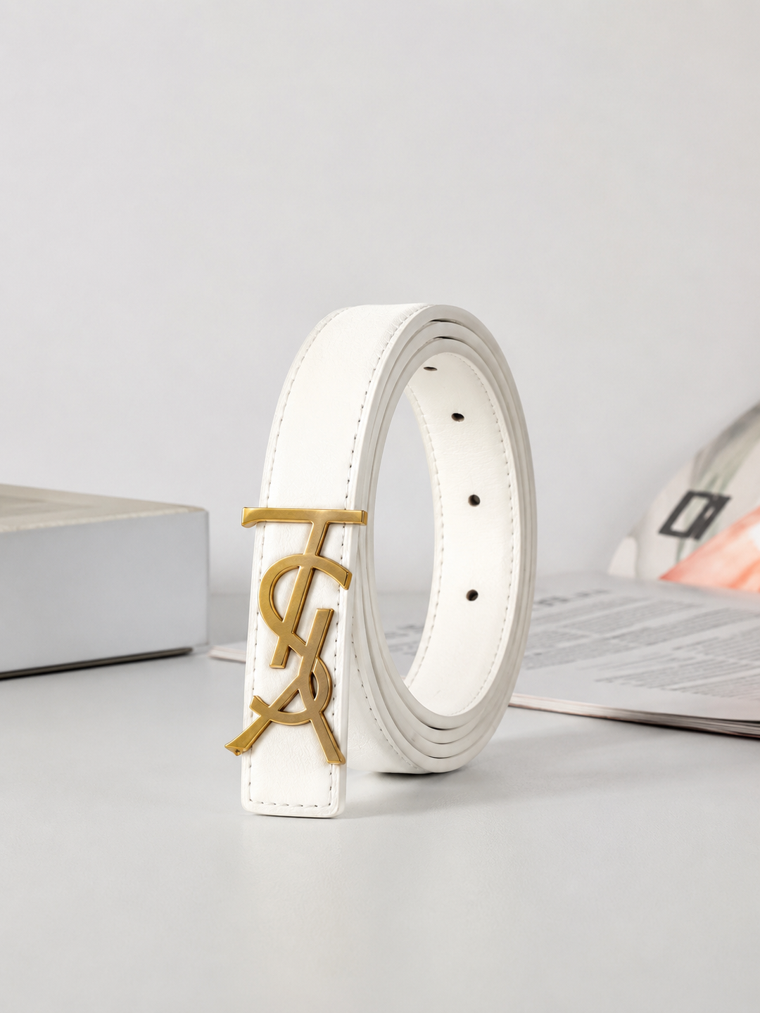 White slim faux leather belt with gold-tone statement buckle.