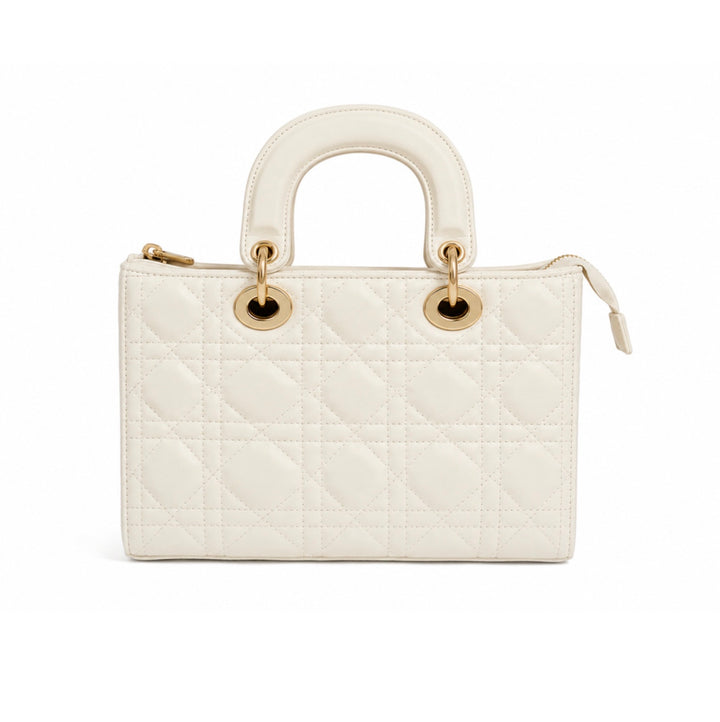 An off-white quilted leather handbag with a top handle, gold-tone hardware, and a zip-around closure, shown against a plain white background.