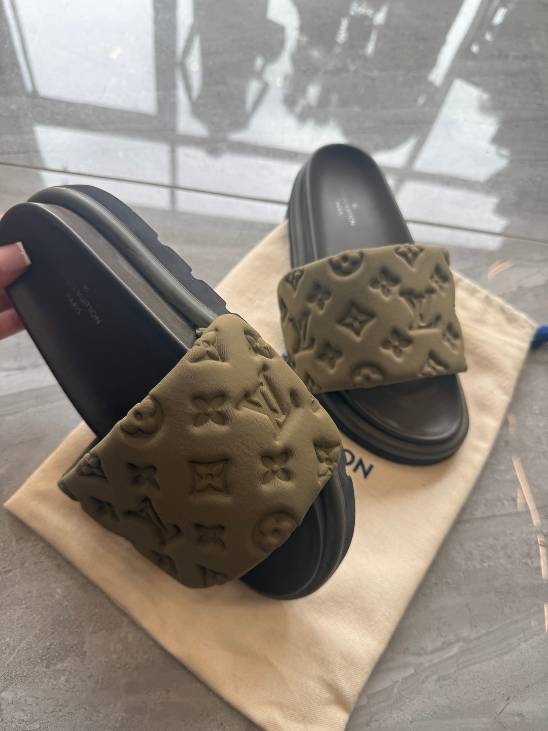 Khaki padded embossed platform sliders with cushioned footbed and chunky sole.