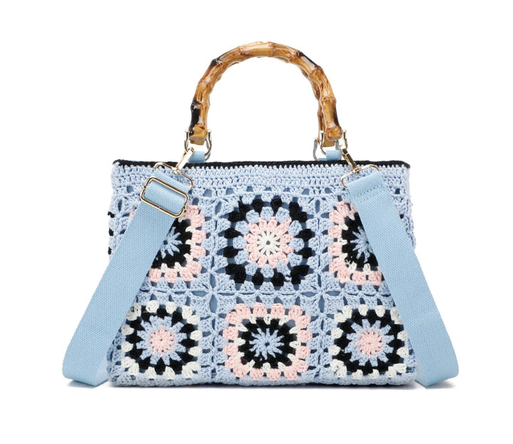 Light blue crochet grab bags with bamboo handles and gold tone metal hardware.