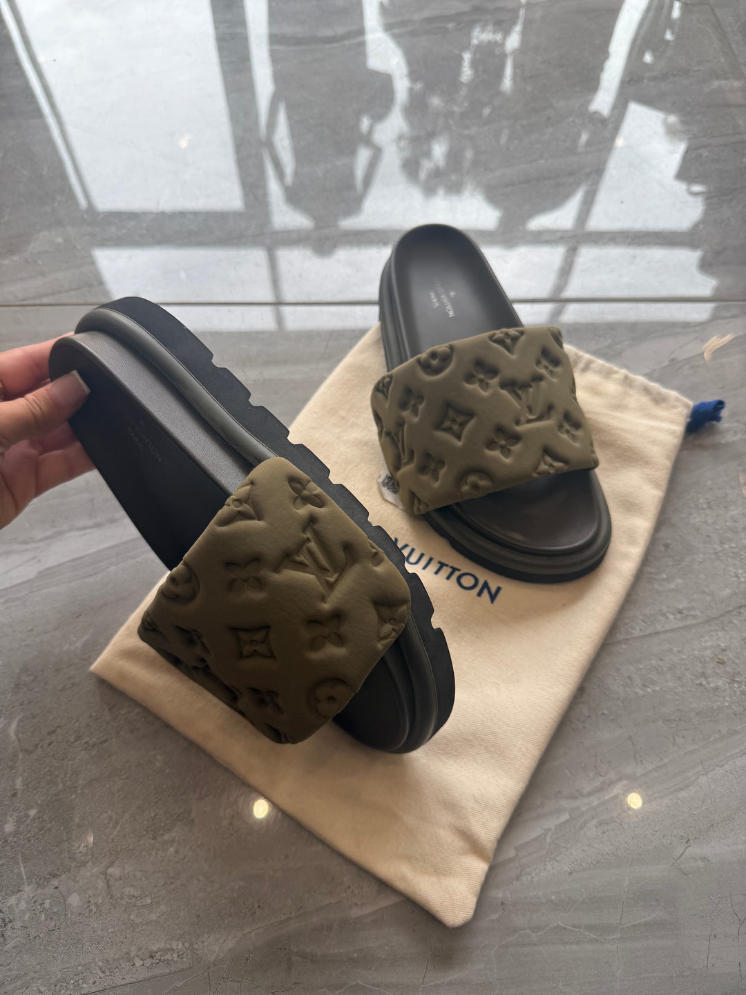 Khaki padded embossed platform sliders with cushioned footbed and chunky sole.