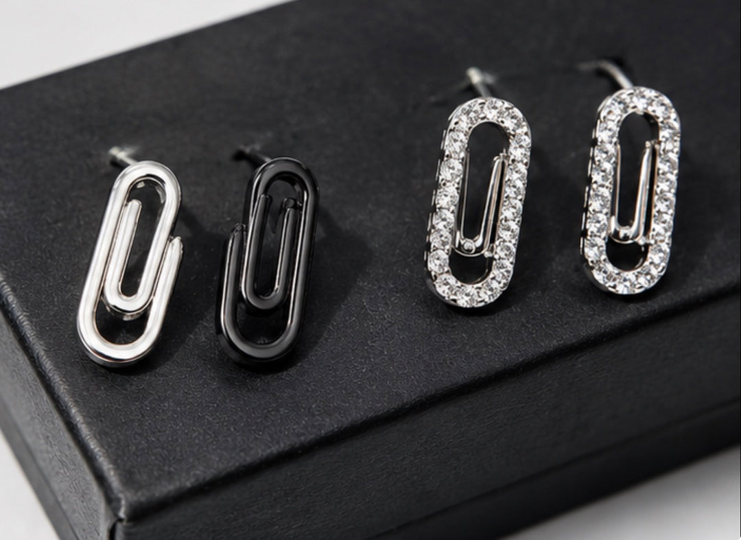 Minimalist silver and crystal paperclip earrings close-up