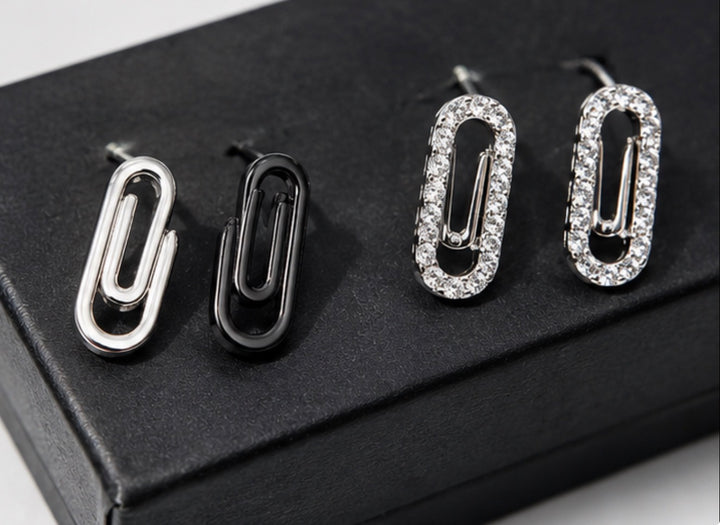 Minimalist silver and crystal paperclip earrings close-up