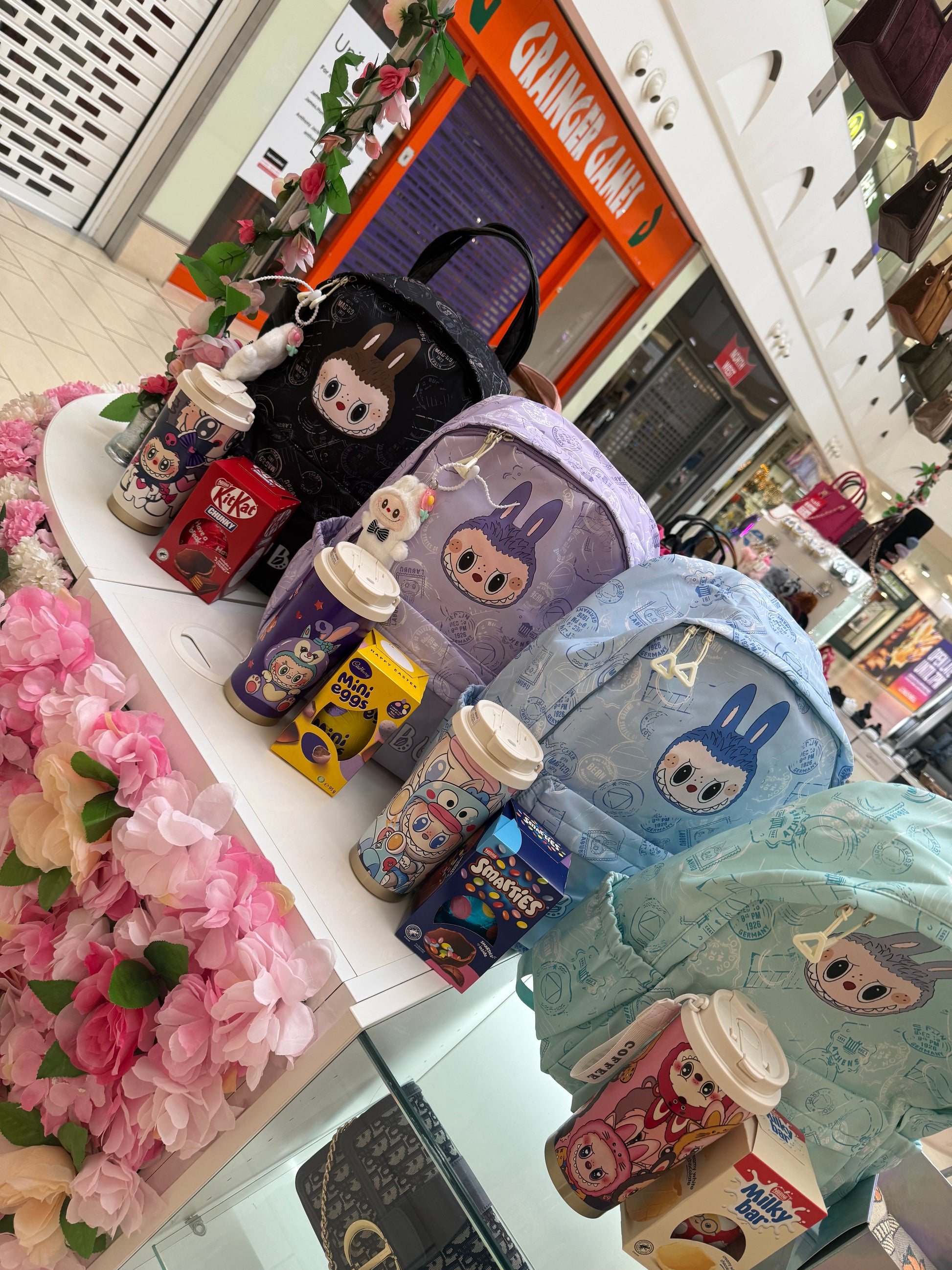 Colourful children’s backpacks with matching water bottle and Easter eggs 