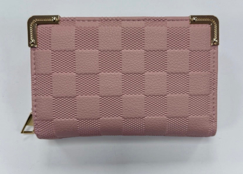 A pink quilted checked purse with gold-coloured edges and a zipper closure.