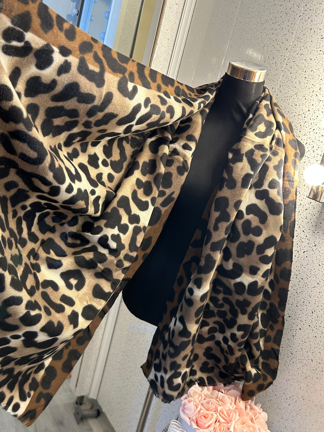 A leopard print scarf with frayed edges