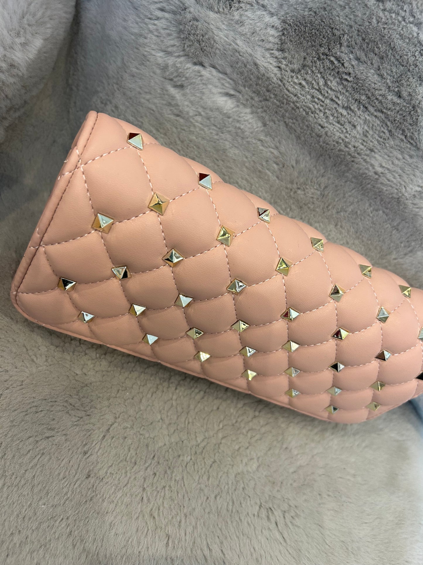 Pink studded clutch bag