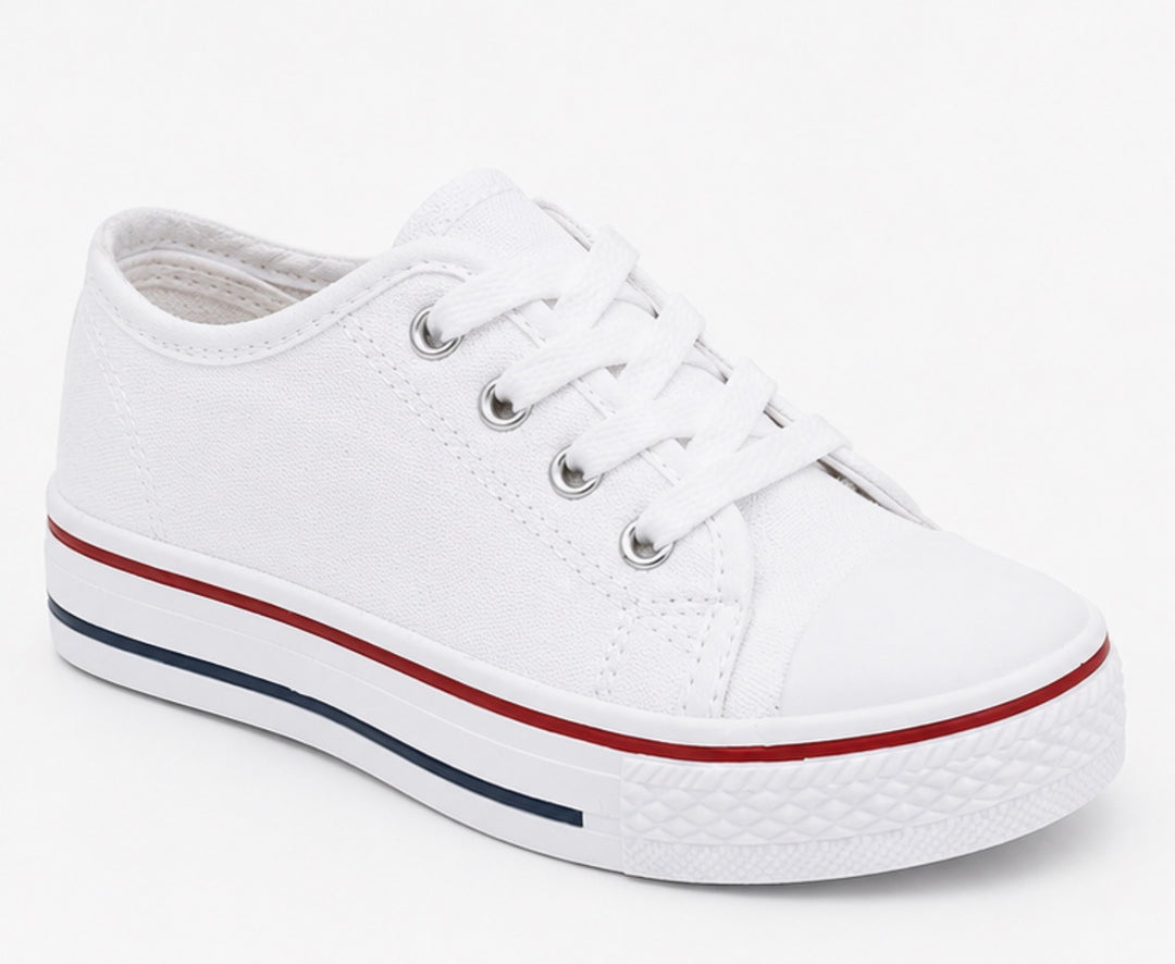 White kids canvas trainers with lace-up fastening and classic chunky sole design.