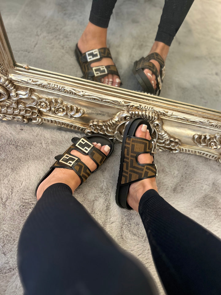 Brown and black patterned sliders with gold buckle detail