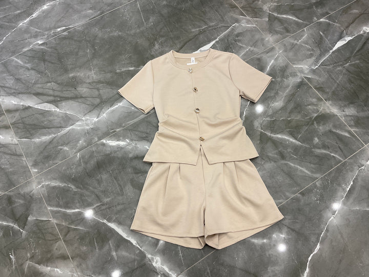 cream co ord set flat lay gold button detail top and tailored shorts