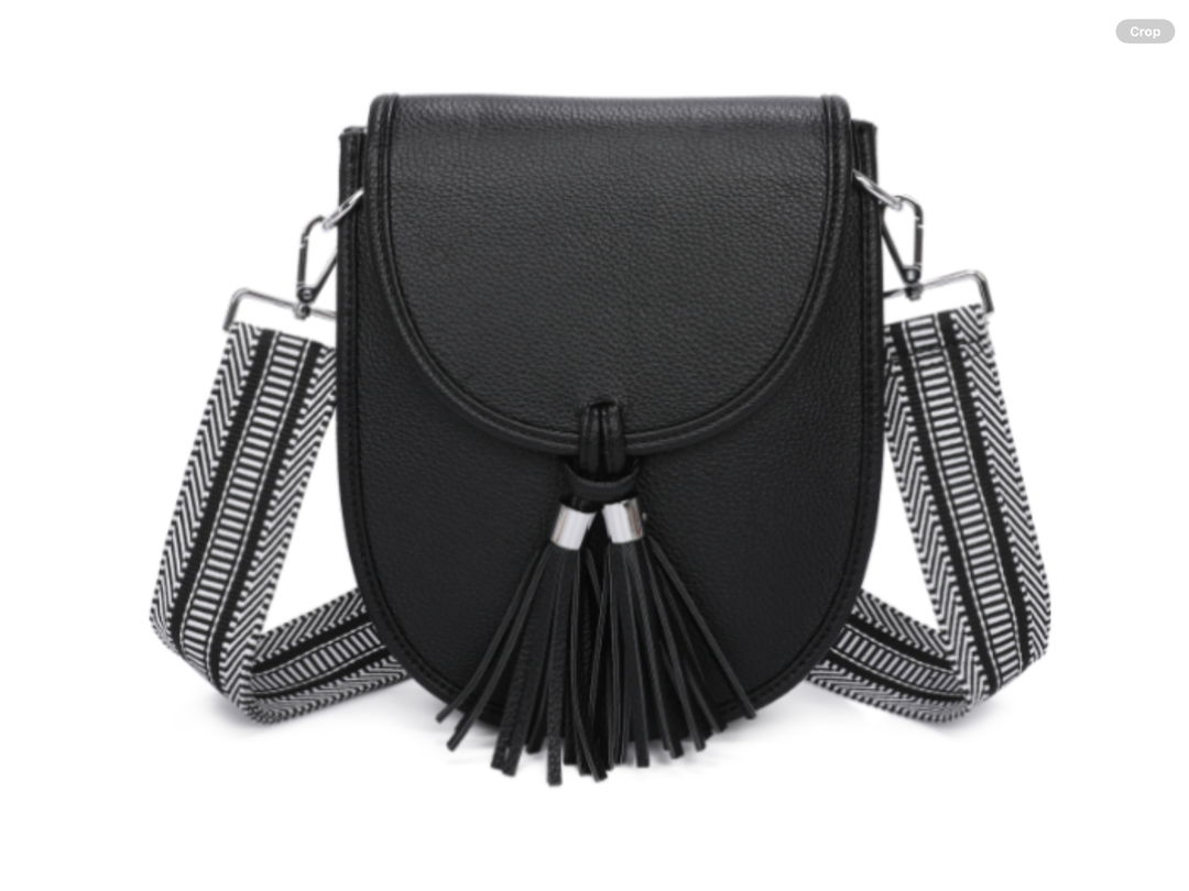 Black handbag with tassels and a striped strap