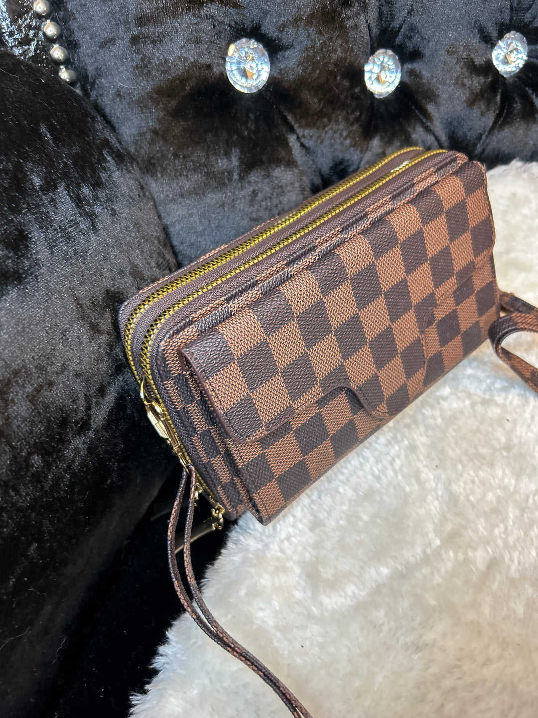 A brown faux leather mini crossbody purse handbag with a checkered pattern.
