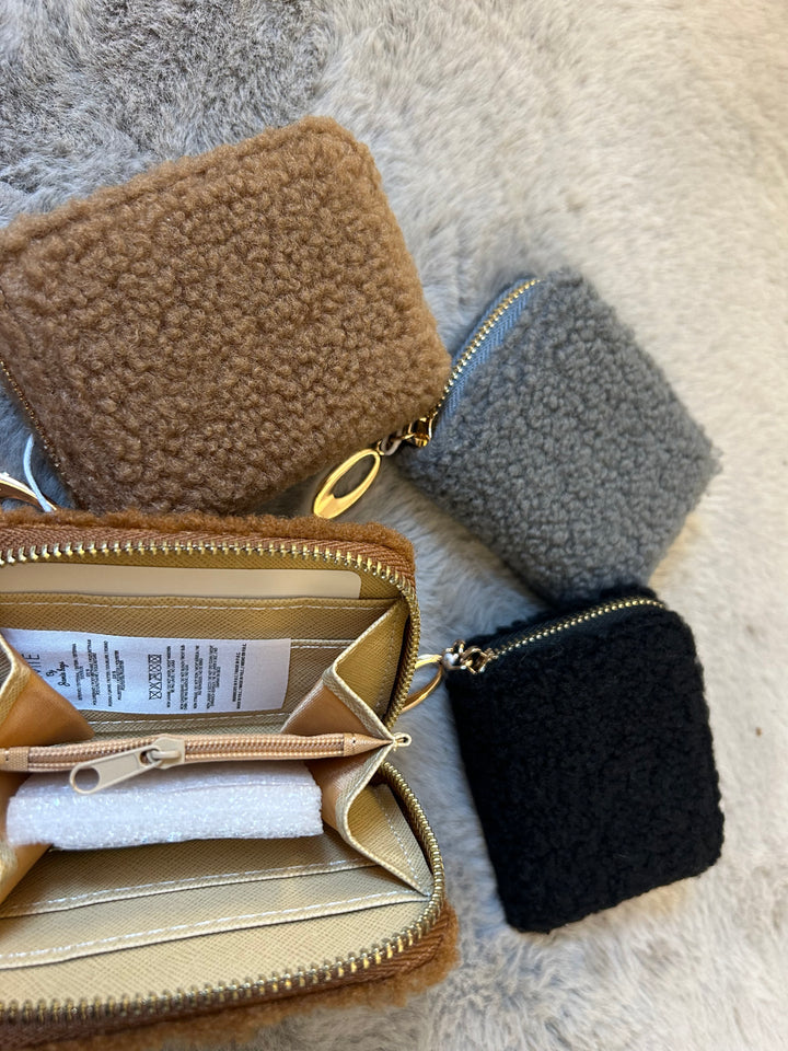 A fuzzy mini purses with gold zip detailing 
