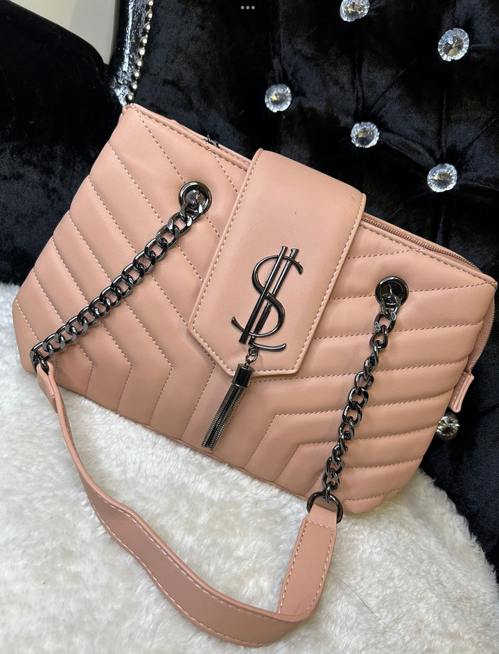 Pink quilted medium size handbag with metal hardware, chain straps and flap closure
