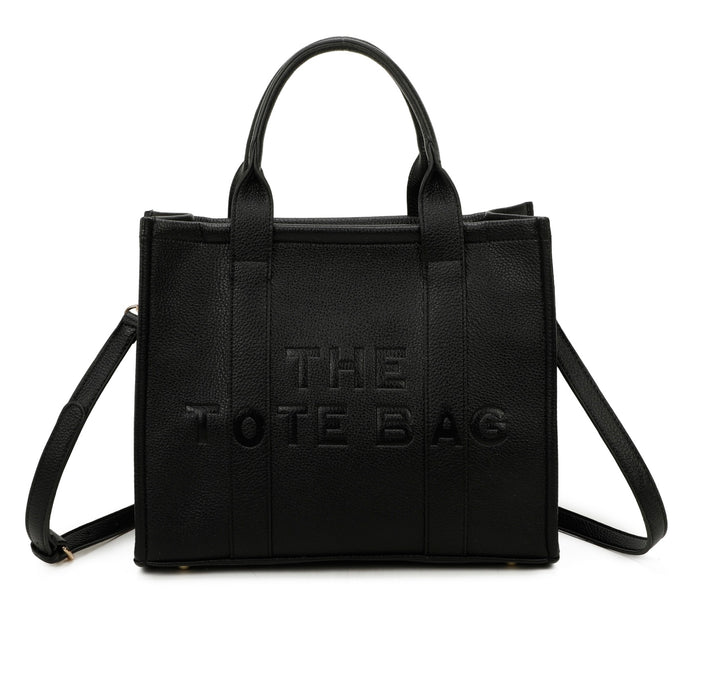 A black tote bag with embossed ‘The Tote Bag’ text, structured design with top handles and detachable shoulder strap