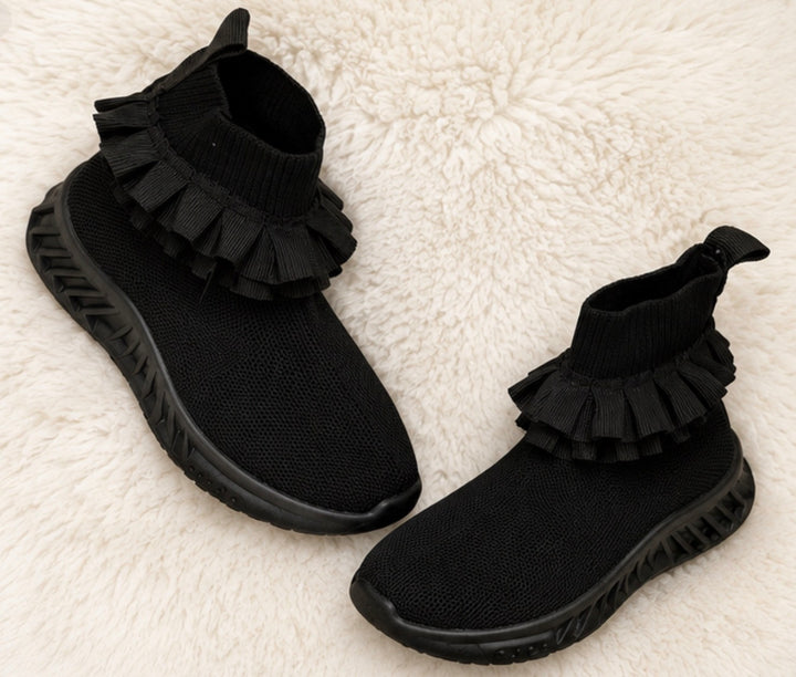 Black kids’ sock-style trainers with layered ruffle ankle detail and chunky black sole