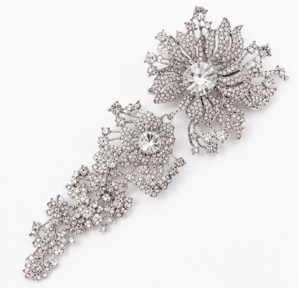 Silver crystal cascading floral statement brooch with large flower and sparkling drop detail