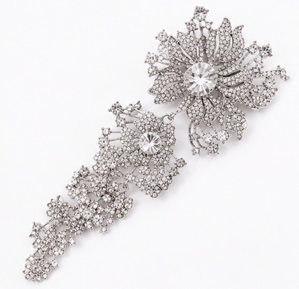 Silver crystal cascading floral statement brooch with large flower and sparkling drop detail