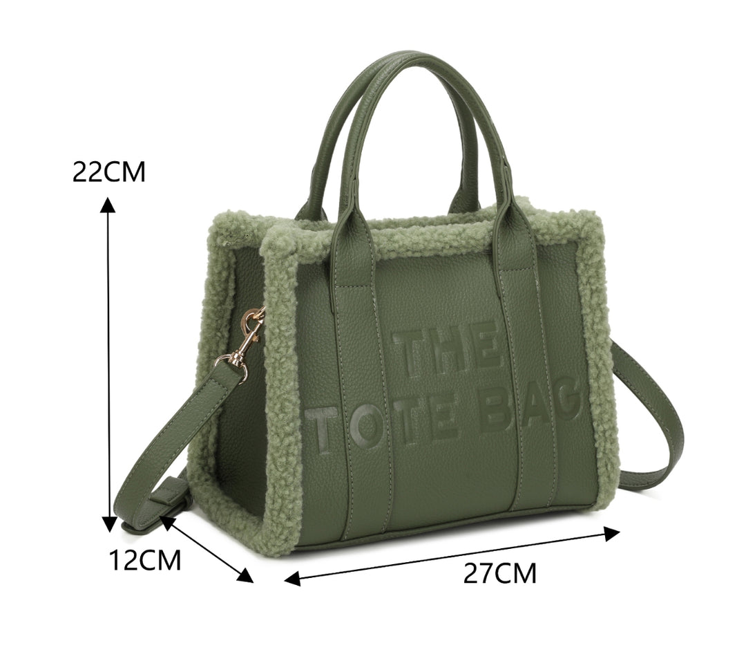 Tote bags with fuzzy edge trim, embossed with ‘The Tote Bag’ on the front