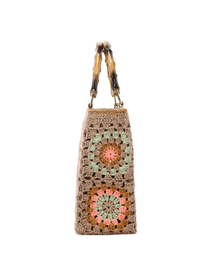 Beige crochet grab bags with bamboo handles and gold tone metal hardware.