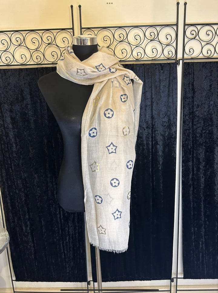 Thin lightweight scarf with flower print design, ideal for spring and summer wear.