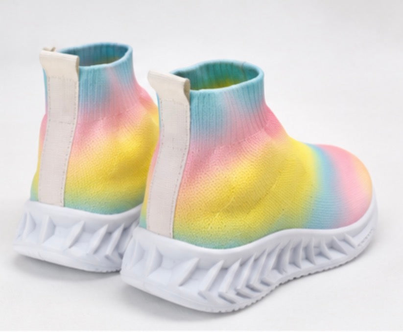 Children’s rainbow slip-on trainers with soft sock-style fit and chunky white grip sole