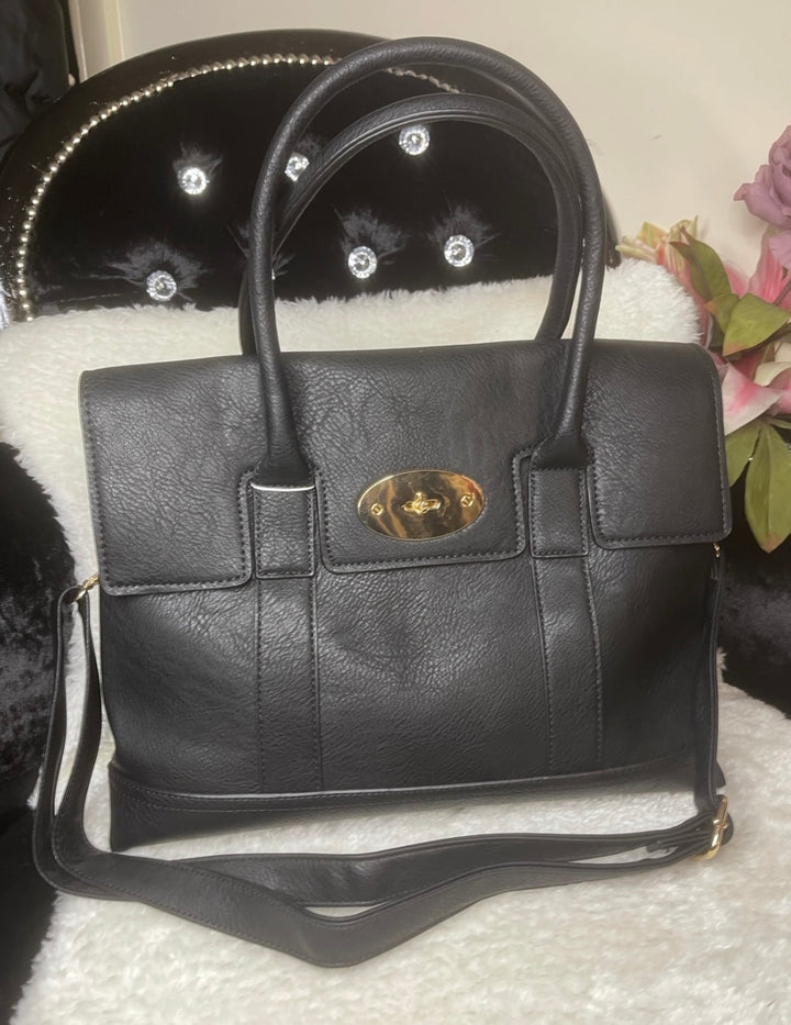 A classic black handbag with elegant gold detailing, featuring a flap with twist metal lock closure, twin shoulder straps, and golden tone metal hardware.