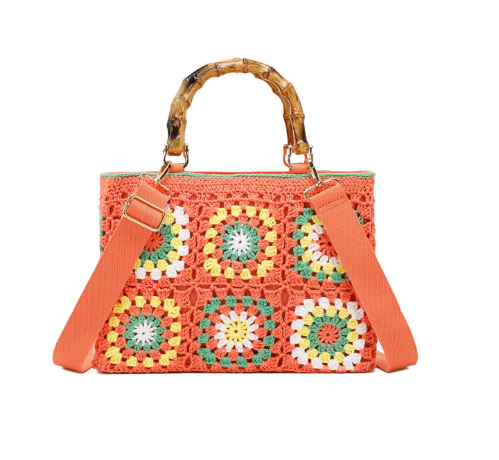 Orange crochet grab bags with bamboo handles and gold tone metal hardware.