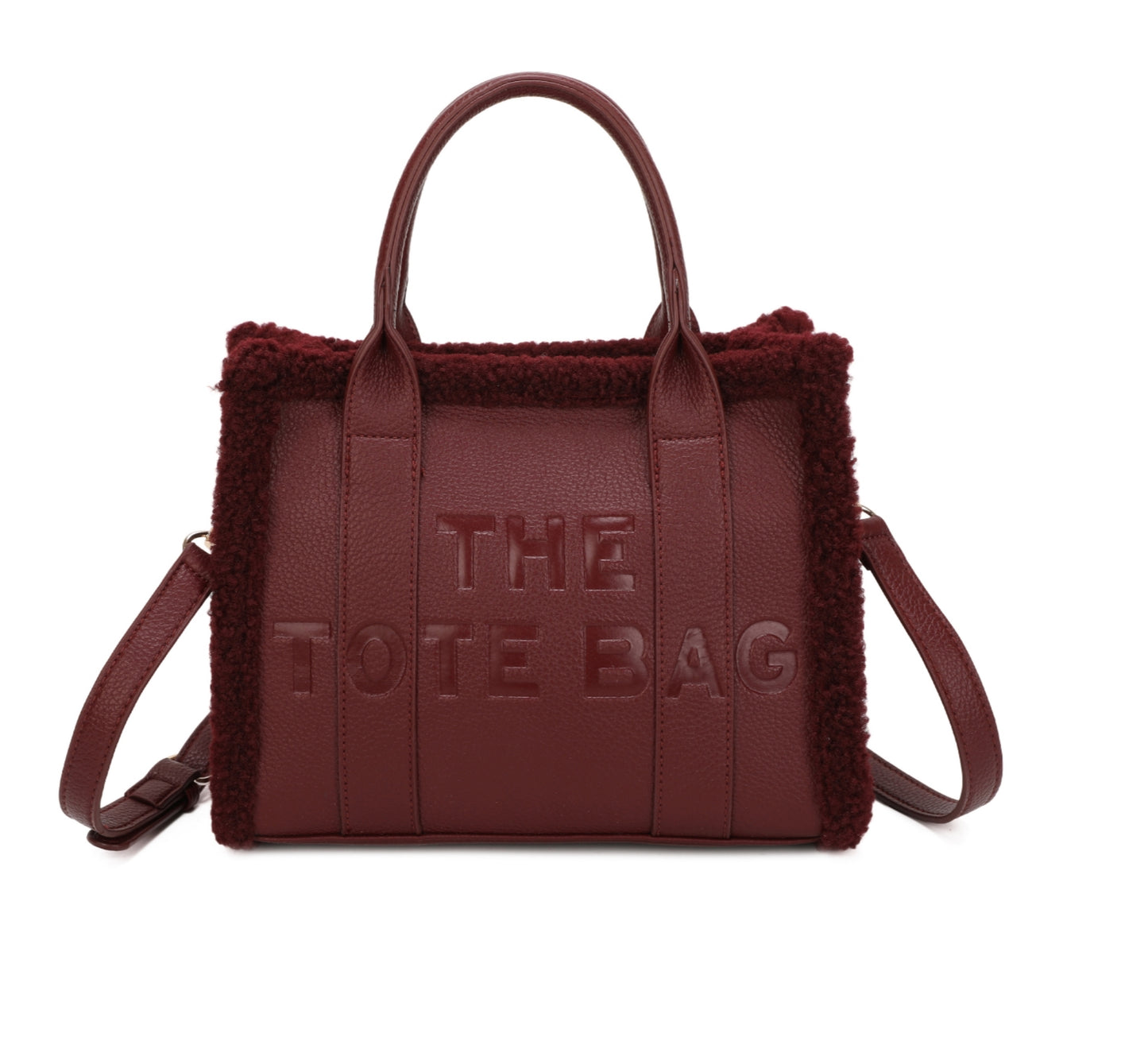 Tote bags with fuzzy edge trim, embossed with ‘The Tote Bag’ on the front in wine 