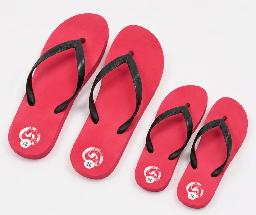 Red flip flops with black straps and lightweight foam sole